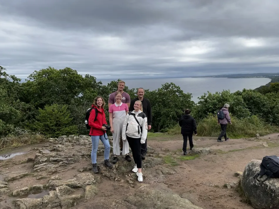 Stens Huvud nationalpark, fem personer ser in i kameran och i bakgrunden syns havet. 
